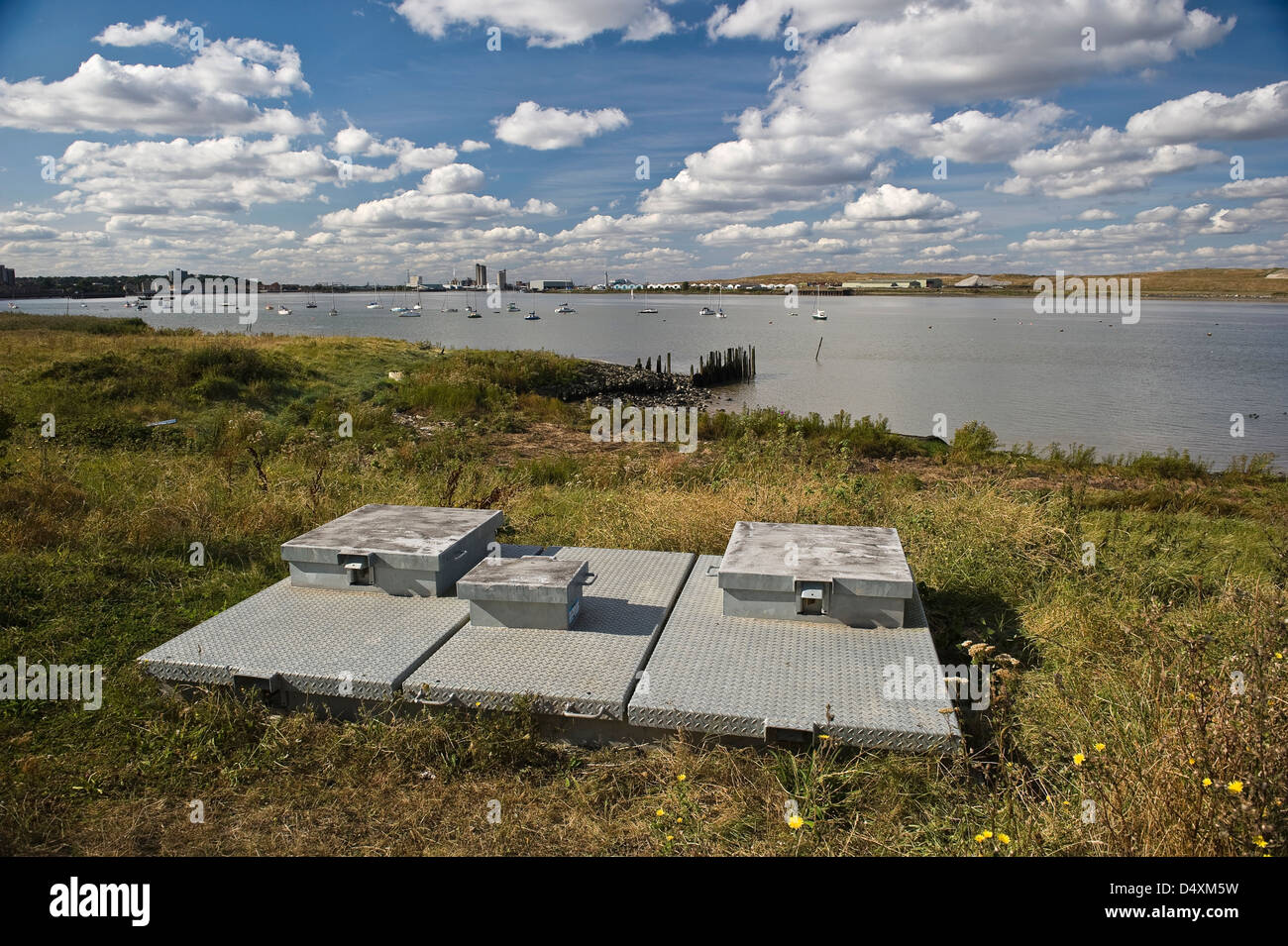 Flood defense pumps on the side of the River Thames near Erith, Kent, UK Stock Photo