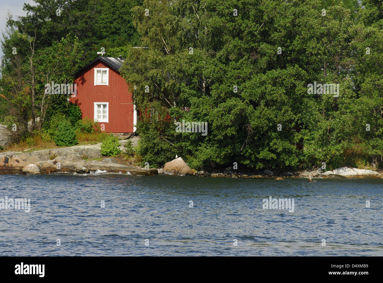 Red wooden house by the sea Stock Photo
