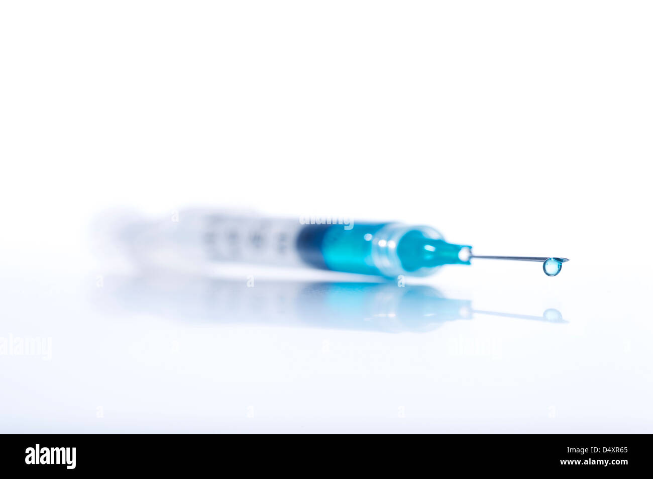 Syringe with needle with Blue liquid drop, Injection Stock Photo