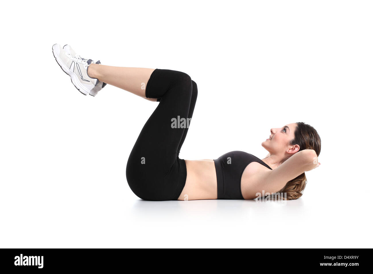 Beautiful woman doing abdominal crunches on a white isolated background Stock Photo