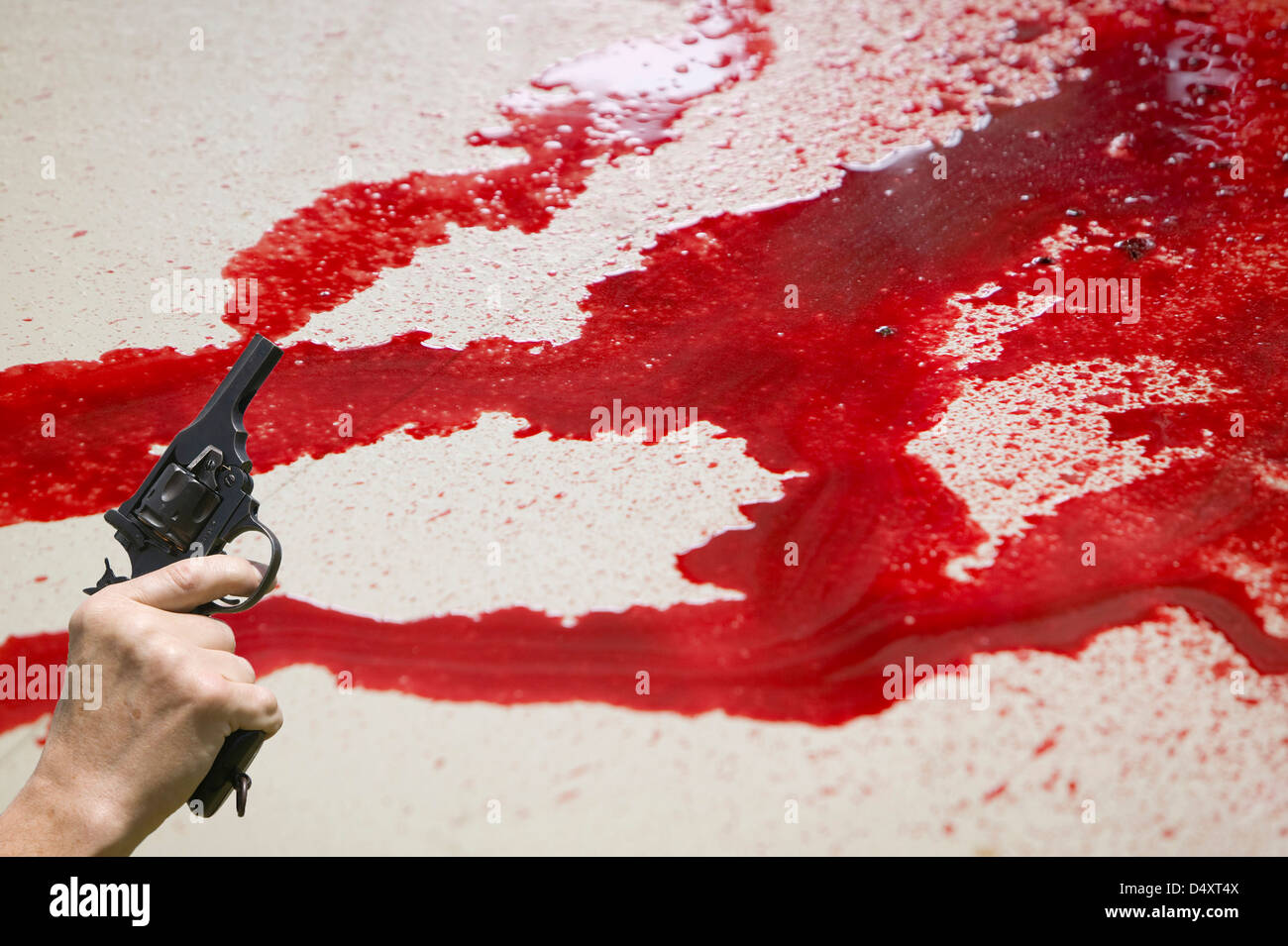 Seal blood from butchering by an Inuit man in Ilulissat in Greenland, and a hand gun. Stock Photo