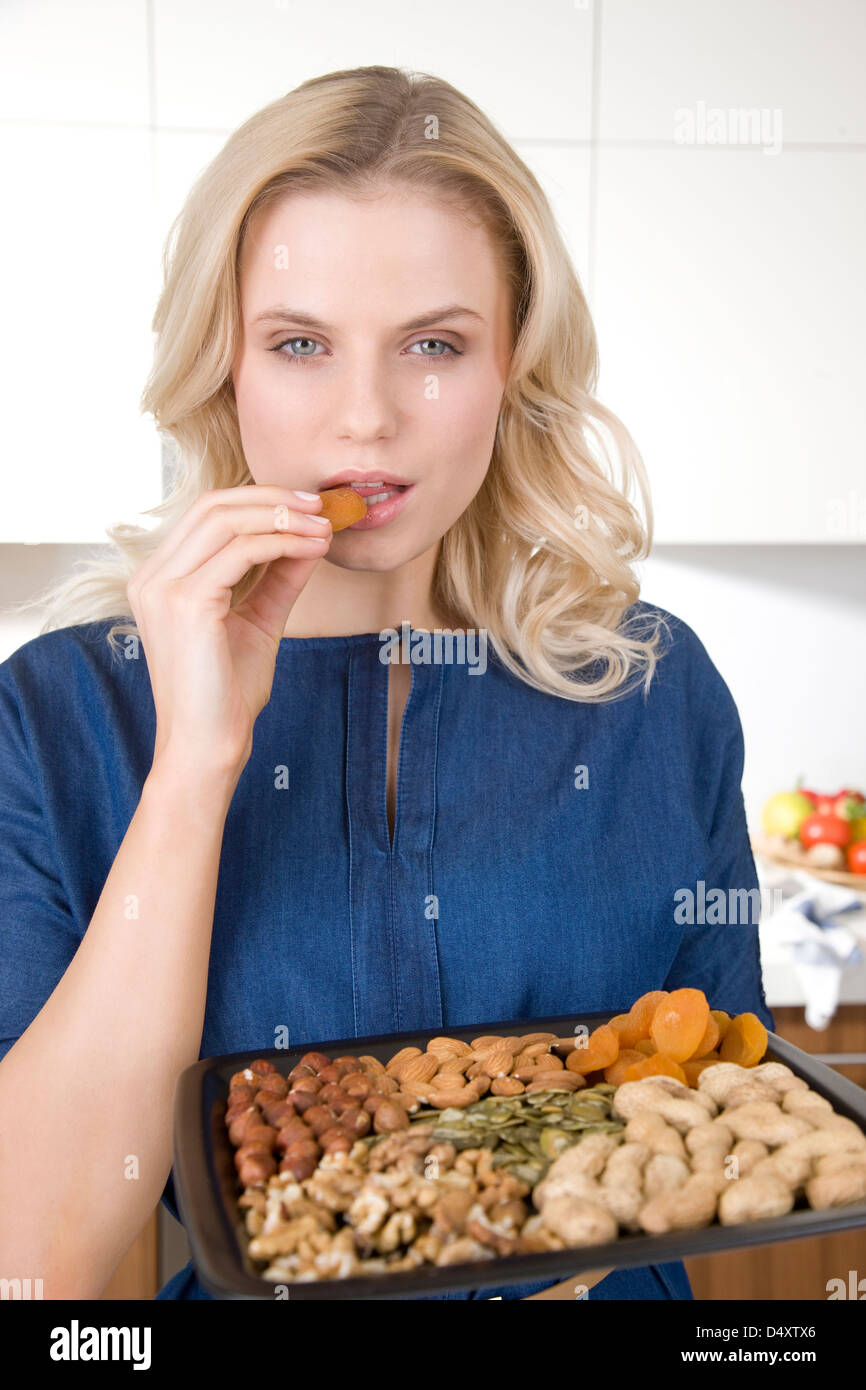 Woman eating nuts and dried fruits Stock Photo Alamy