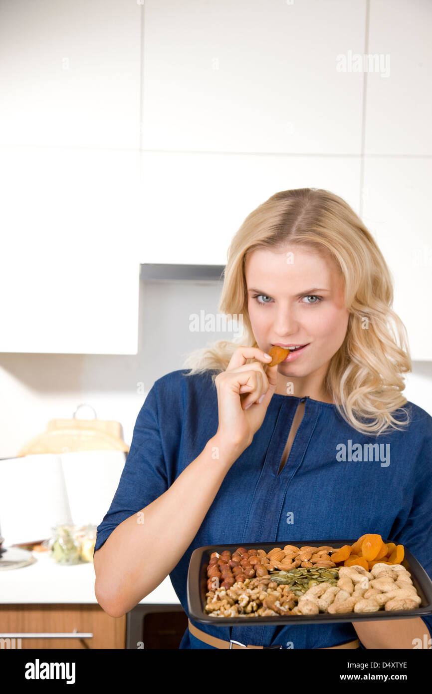 Woman eating nuts and dried fruits Stock Photo Alamy