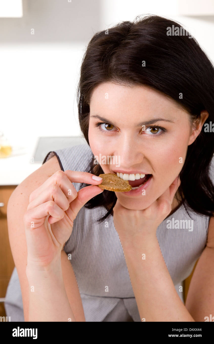 Woman eating wholegrain rusk Stock Photo - Alamy