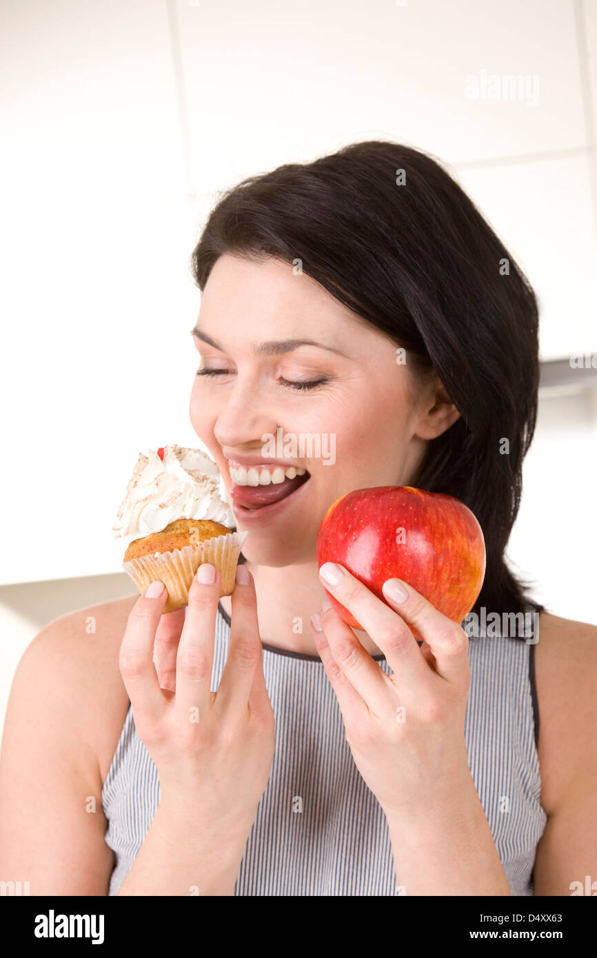 Woman holding cake and apple Stock Photo