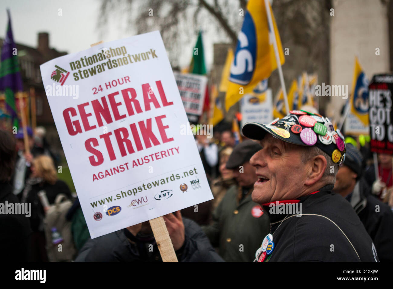 London, UK. 20th March 2013. Protestor holds General Strike placard at PCS rally held by striking members outside the Houses of Parliament. Credit:  martyn wheatley / Alamy Live News Stock Photo