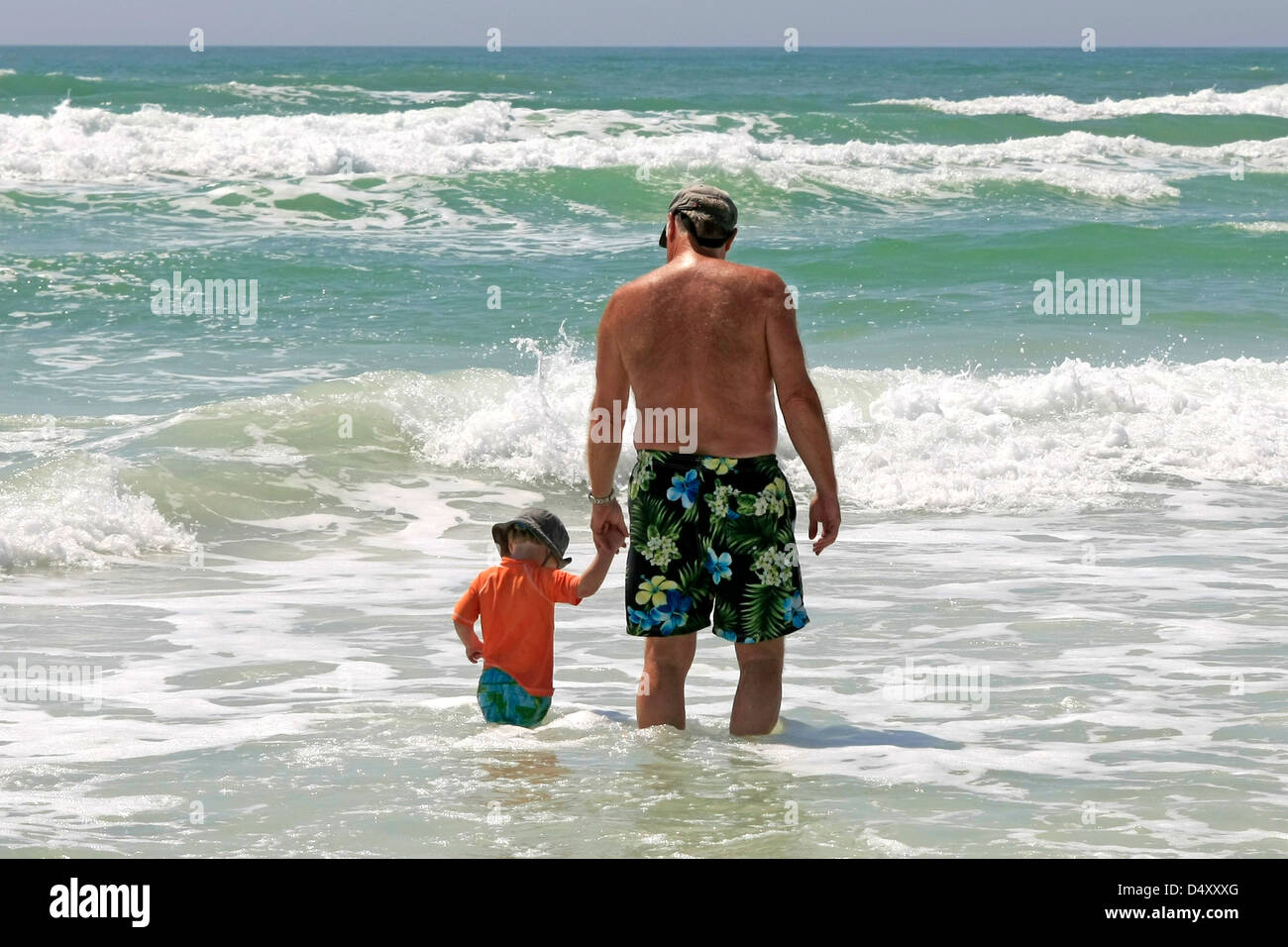 Father and young son enjoying the surf on Siesta Key beach Florida during Spring Break Stock