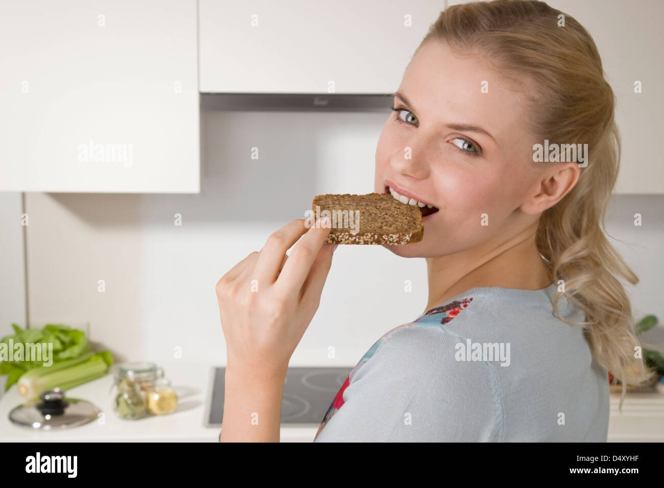 Woman eating wholemeal bread Stock Photo