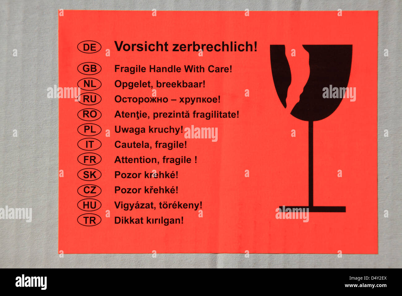 Red Warning  Fragile Sticker on Cardboard Box in many European Languages. Photo by Willy Matheisl Stock Photo