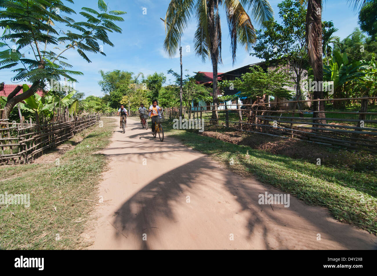 children riding bicycles in rural Laos, 4000 islands in the Mekong Stock Photo