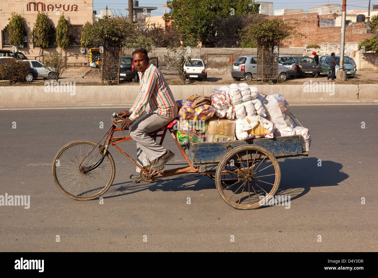 A Punjabi man with a rickshaw loaded with snacks and food on the streets of Amritsar Punjab India Stock Photo