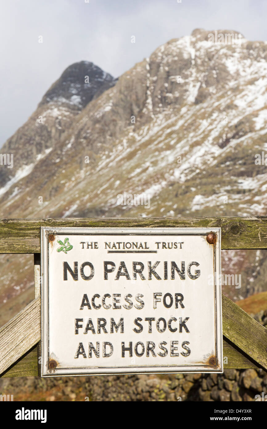 A no parking sign in Langale with Pike o Stickle in the Lake District, UK. Stock Photo