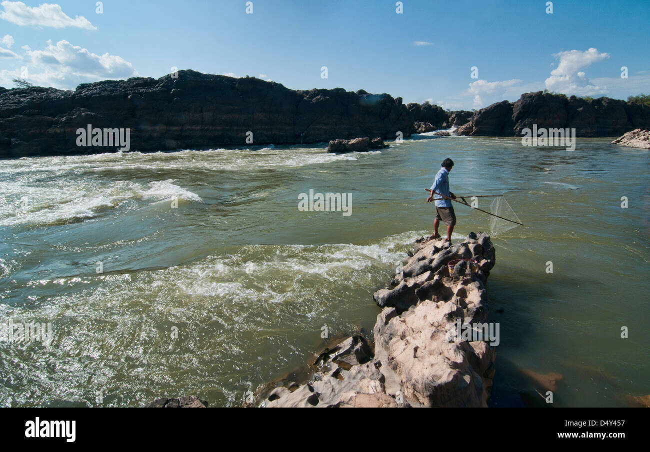 fisherman and his net in the Mekong River on Don Khone Island, Laos Stock Photo