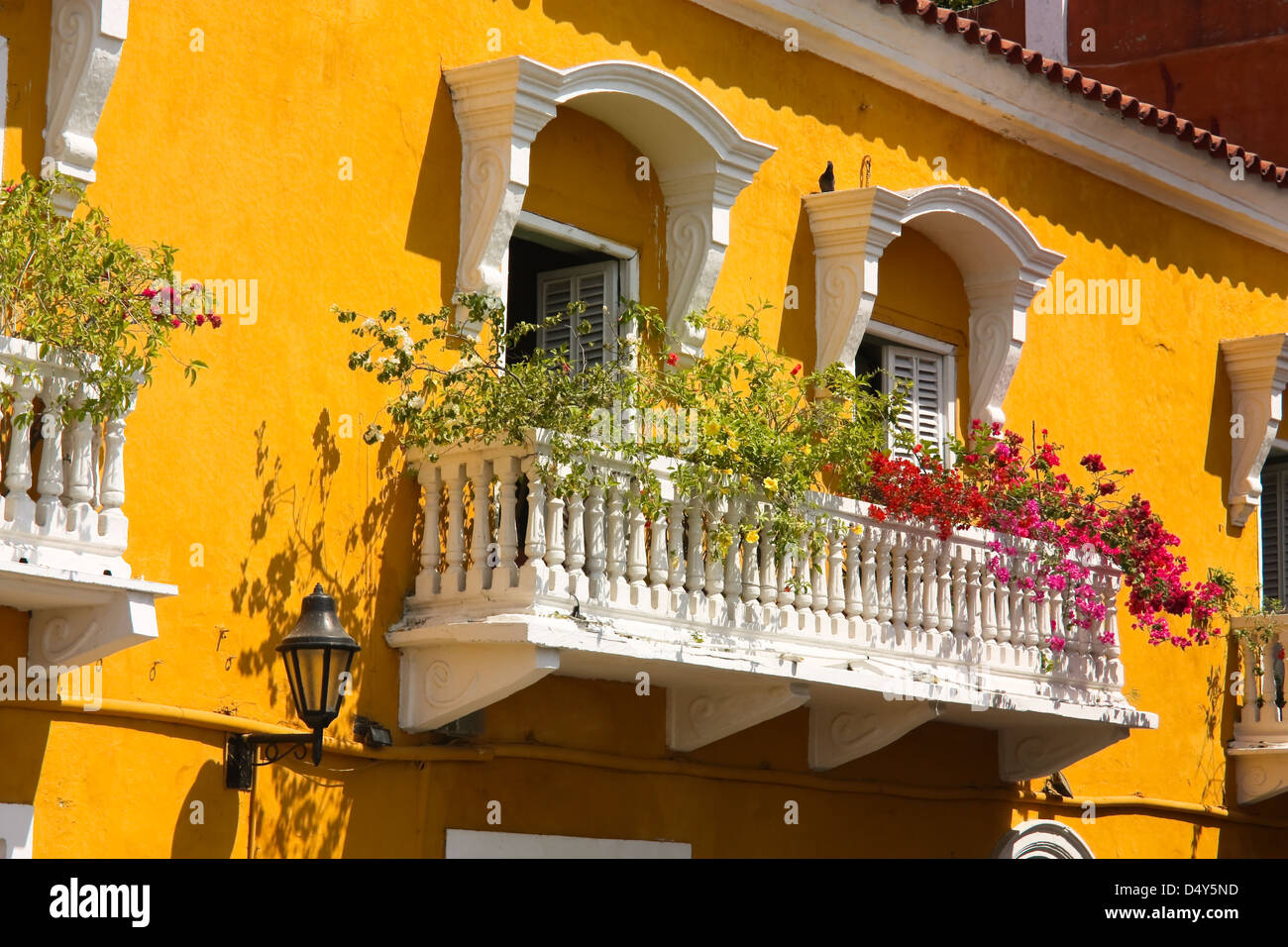 Detail of a colonial house. balcony with flowers. Spanish colonial home