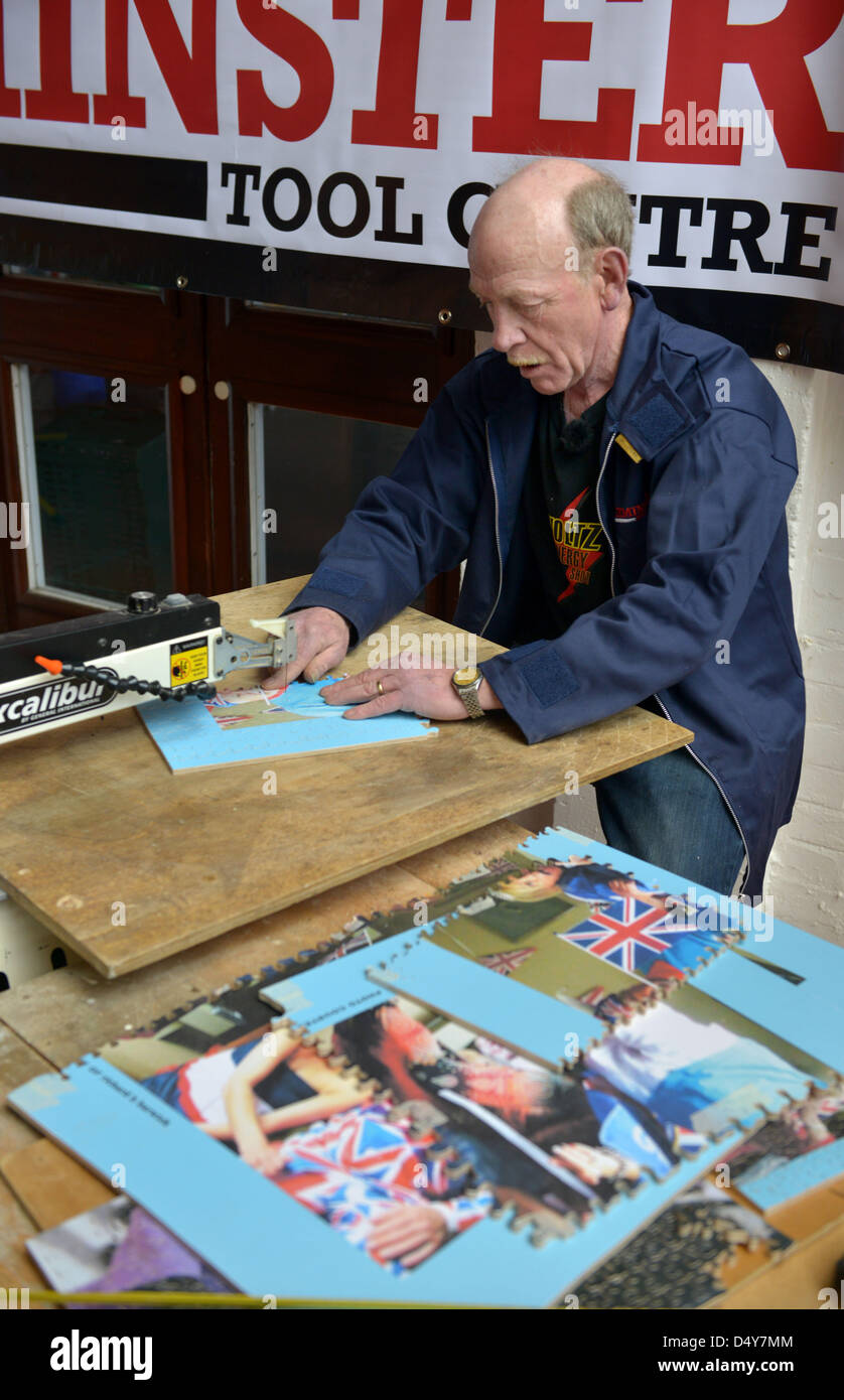 Weymouth, Dorset, UK. 20th March 2013. World record jigsaw attempt, Dave Evans at work on the largest wooden jigsaw in the world at Weymouth, Dorset, UK. The Queen's Diamond Jubilee jigsaw will take him weeks to cut out. Changing hundreds of blades and trying to keep his fingers away from the busy blade!. The 40,000 piece jigsaw will be around 3 metres by 4 metres when finished. 20th March, 2013 Picture by Geoff Moore/Dorset Media Service/Alamy Live News Stock Photo