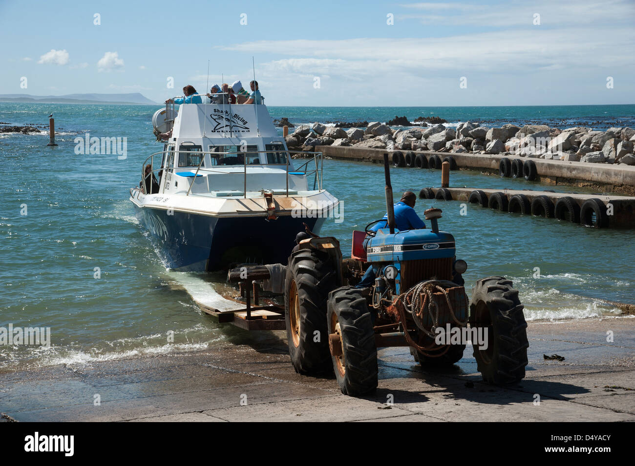 Shark cage dive boat and passengers return to Gansbaai Western Cape South Africa after a diving experience out at sea Stock Photo