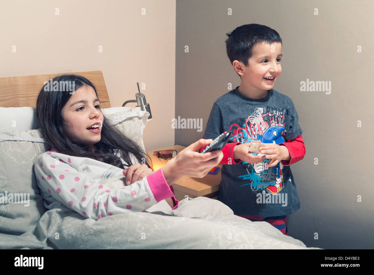 Children watch TV in bed Stock Photo Alamy