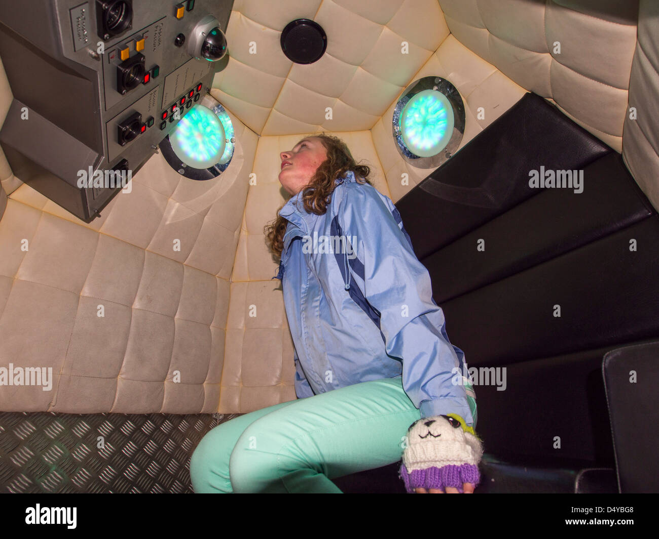 A girl in a space capsule at the National Space Centre in Leicester, UK. Stock Photo