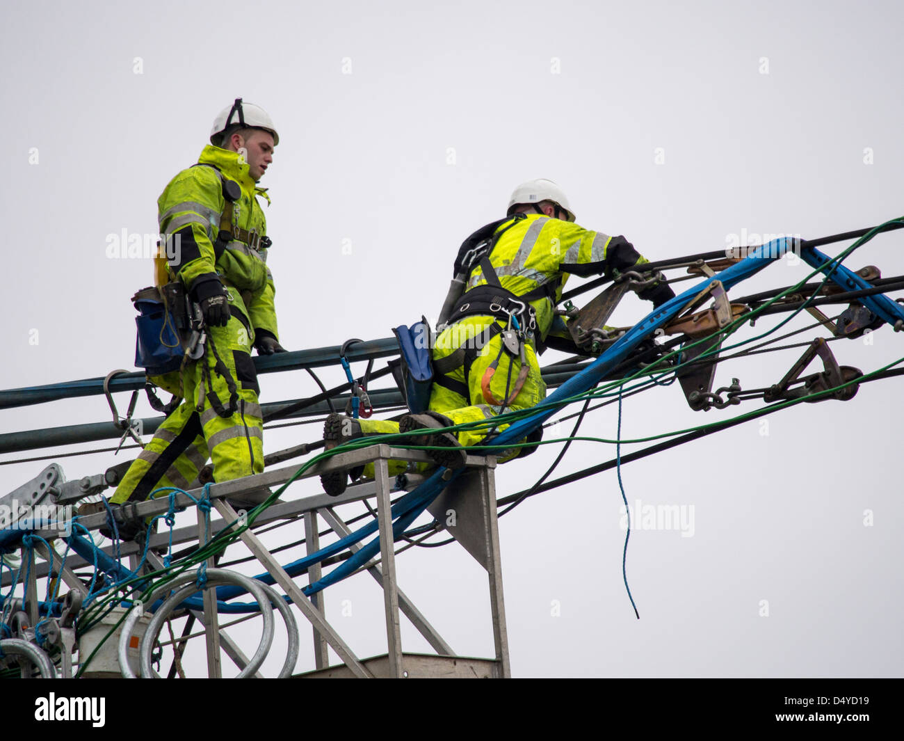 Workmen replacing old insulators on a high voltage power cable in Barrow on soar, Leicesterhsire, UK. Stock Photo