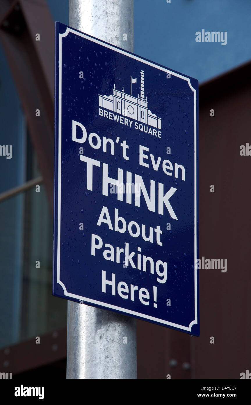 “Don’t even think about parking here!”. A quirky humorous No Parking sign at Brewery Square in Dorchester, Dorset, England, United Kingdom. Stock Photo