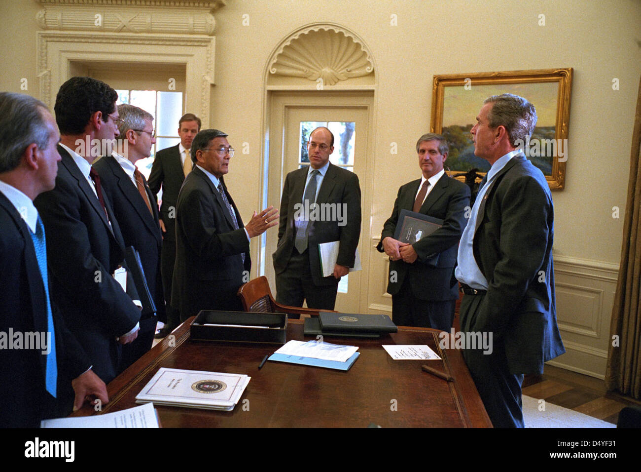 A photograph taken on October 30, 2001, in the Oval Office of the White House showing President George W. Bush meeting with senior advisors, including Nick Calio, Joel Kaplan, and others. This image captures a key moment in early 21st-century U.S. governance. Stock Photo
