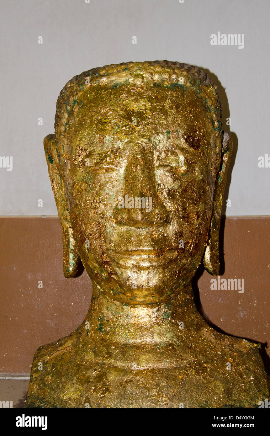 Thailand, Ayutthaya. Phra Mongkonbophit. Ancient stone Buddha head covered in tiny squares of gold leaf. UNESCO Stock Photo