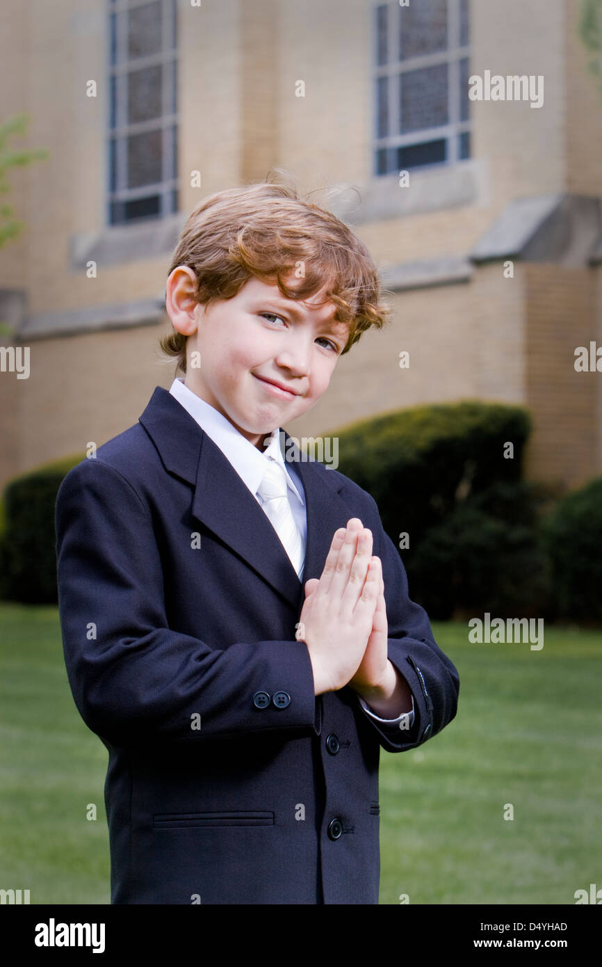 Young boy posing for camera after his Holy Communion or Eucharist ceremony. Stock Photo