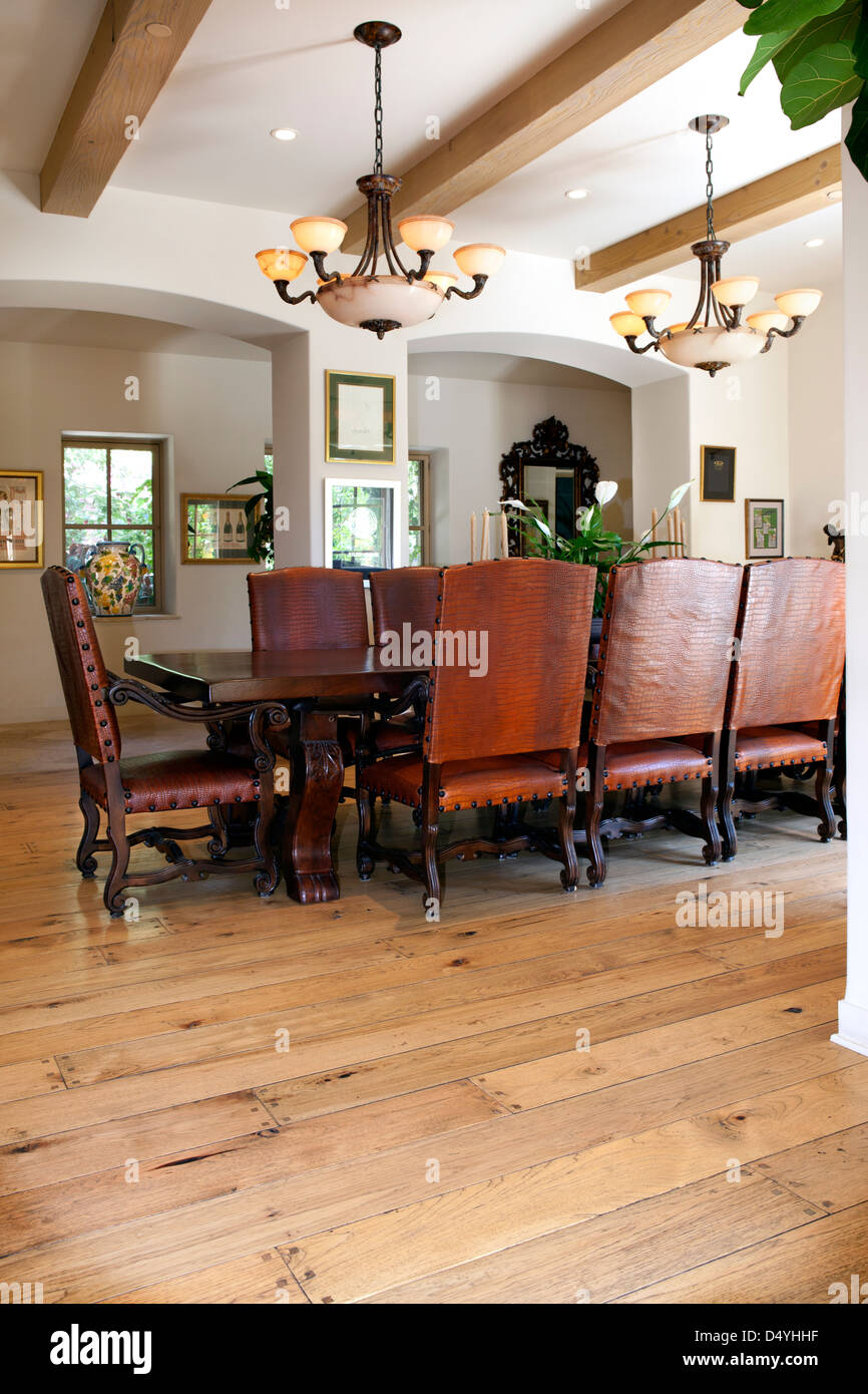 Arranged dining table on hardwood floor, California, USA Stock Photo