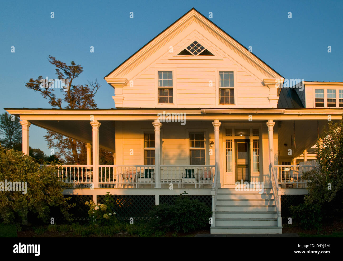 Front exterior traditional home with wrap around porch, Grand Isle, Vermont, USA Stock Photo