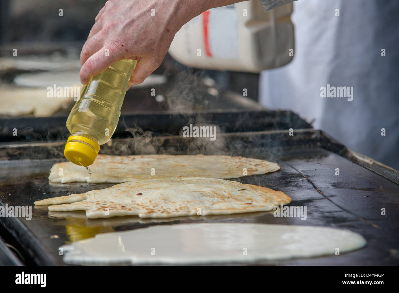 Pancakes cooking on a barbecue hotplate at an outdoor farmers' market in Melbourne Australia Stock Photo