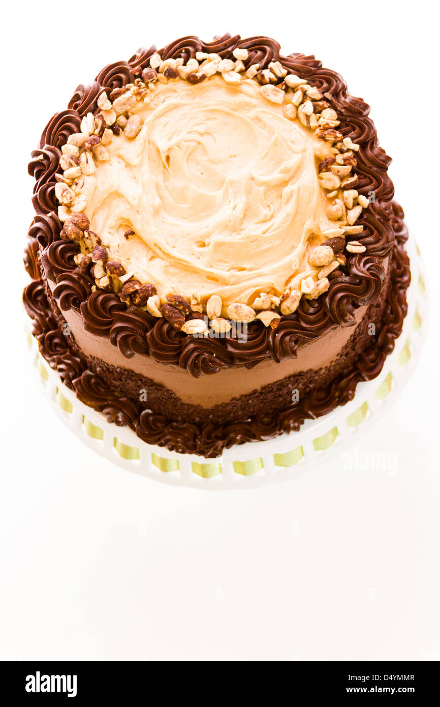 Peanut butter mousse cake with two layers of chocolate cake, filled and