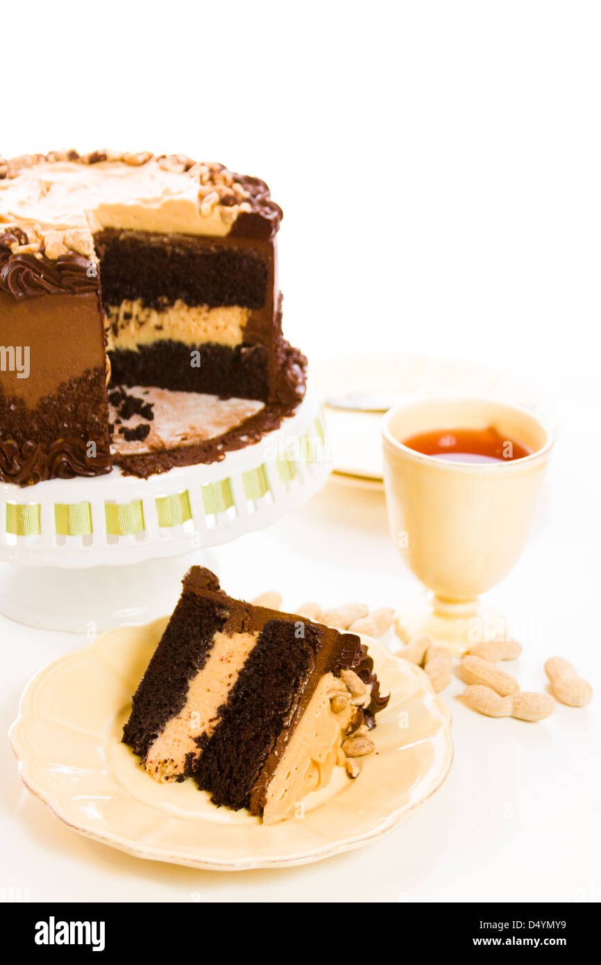 Peanut butter mousse cake with two layers of chocolate cake, filled and