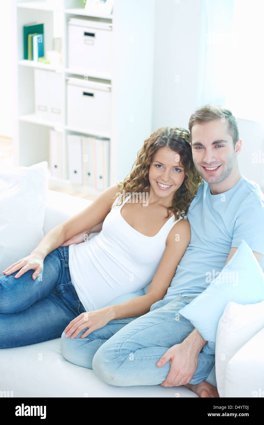 Vertical portrait of a happy couple cuddling at home Stock Photo Alamy