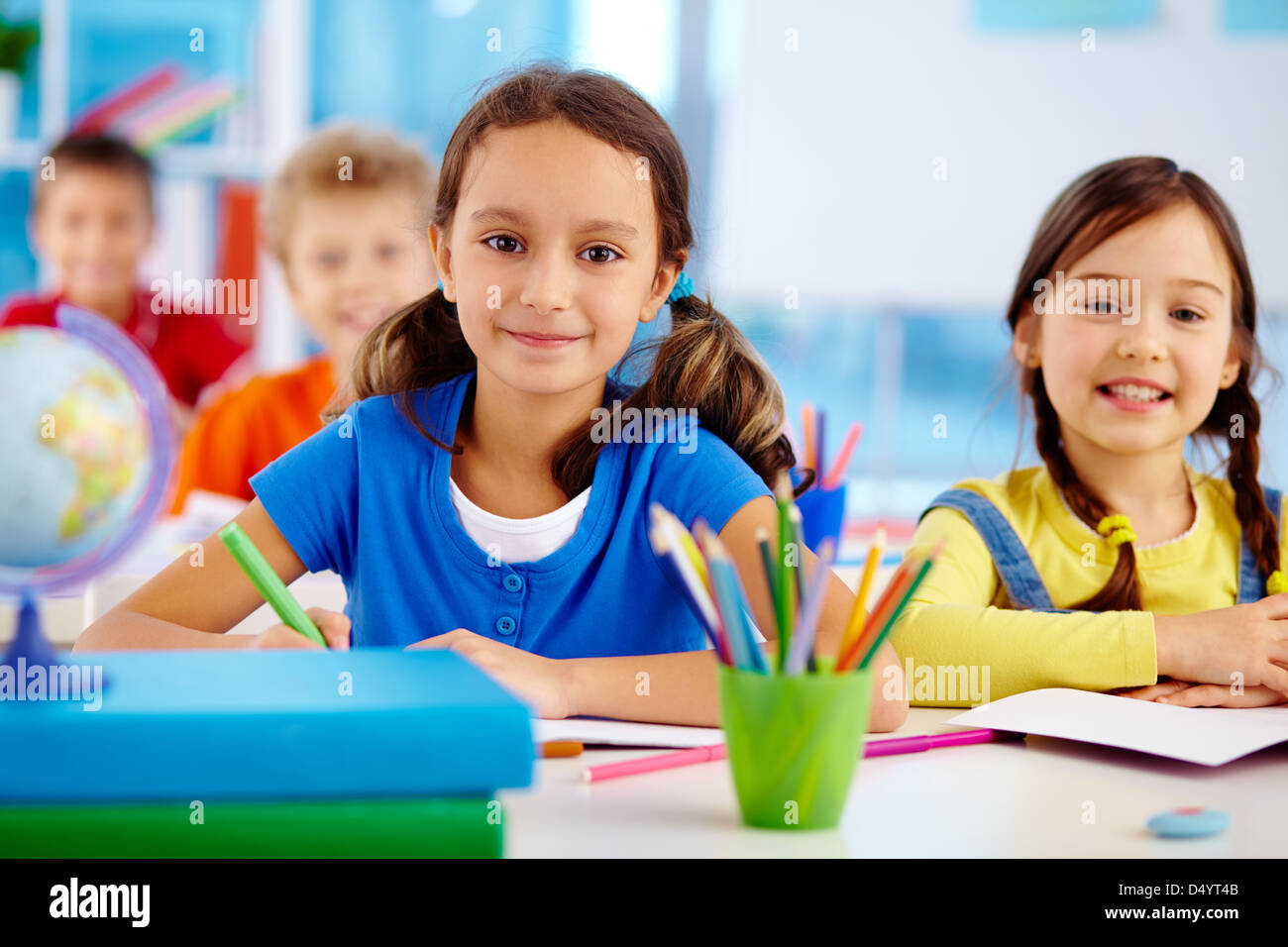 Portrait of happy school children drawing with crayons Stock Photo - Alamy
