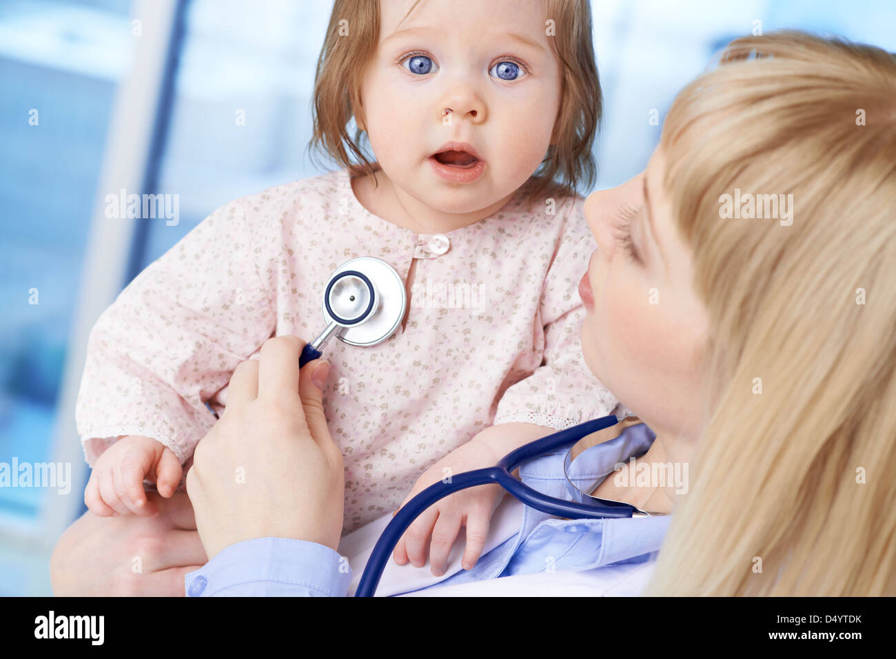 Cute baby being examined by female doctor in hospital Stock Photo