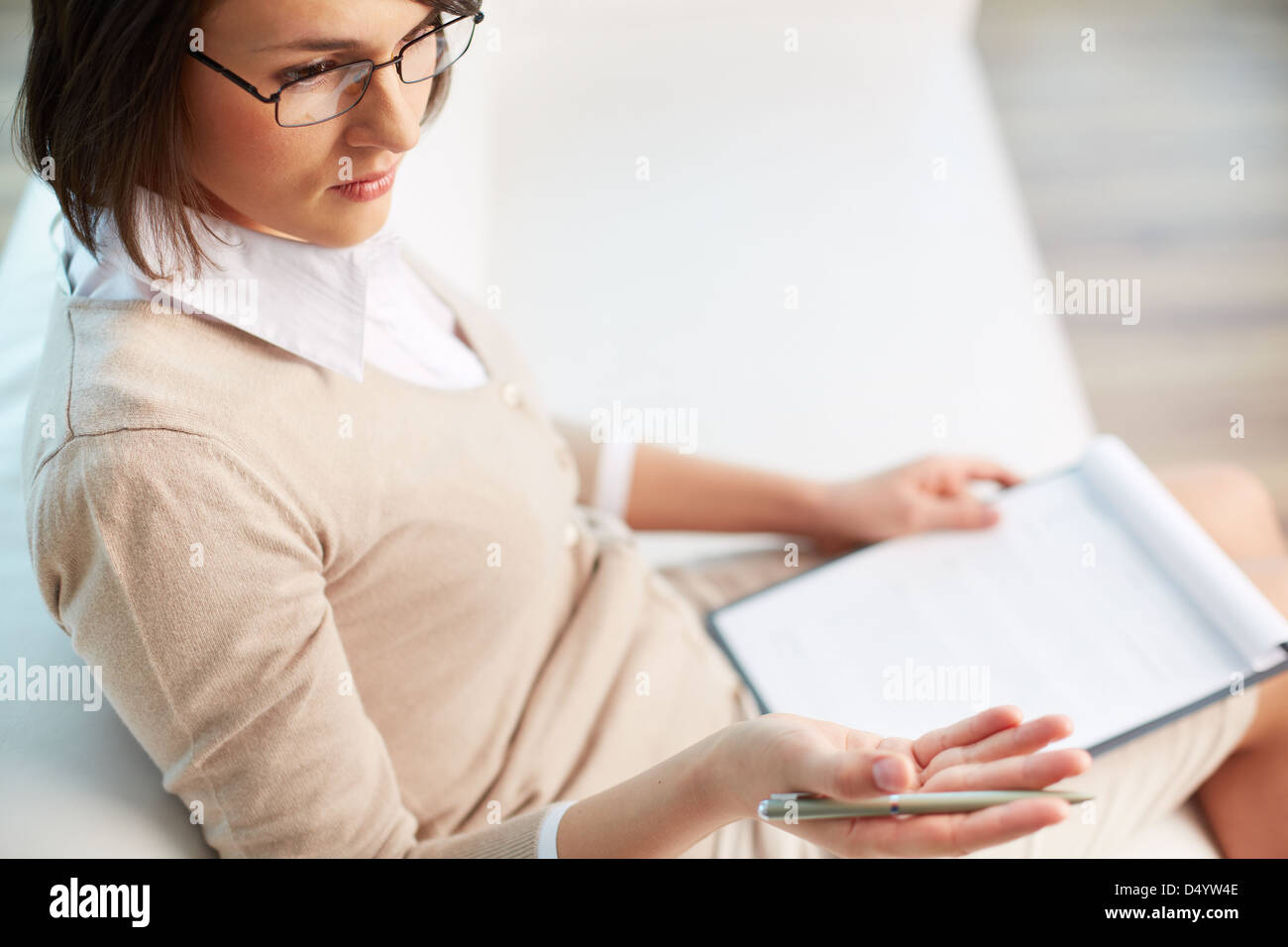 Professional psychiatrist looking at her patient during therapy session