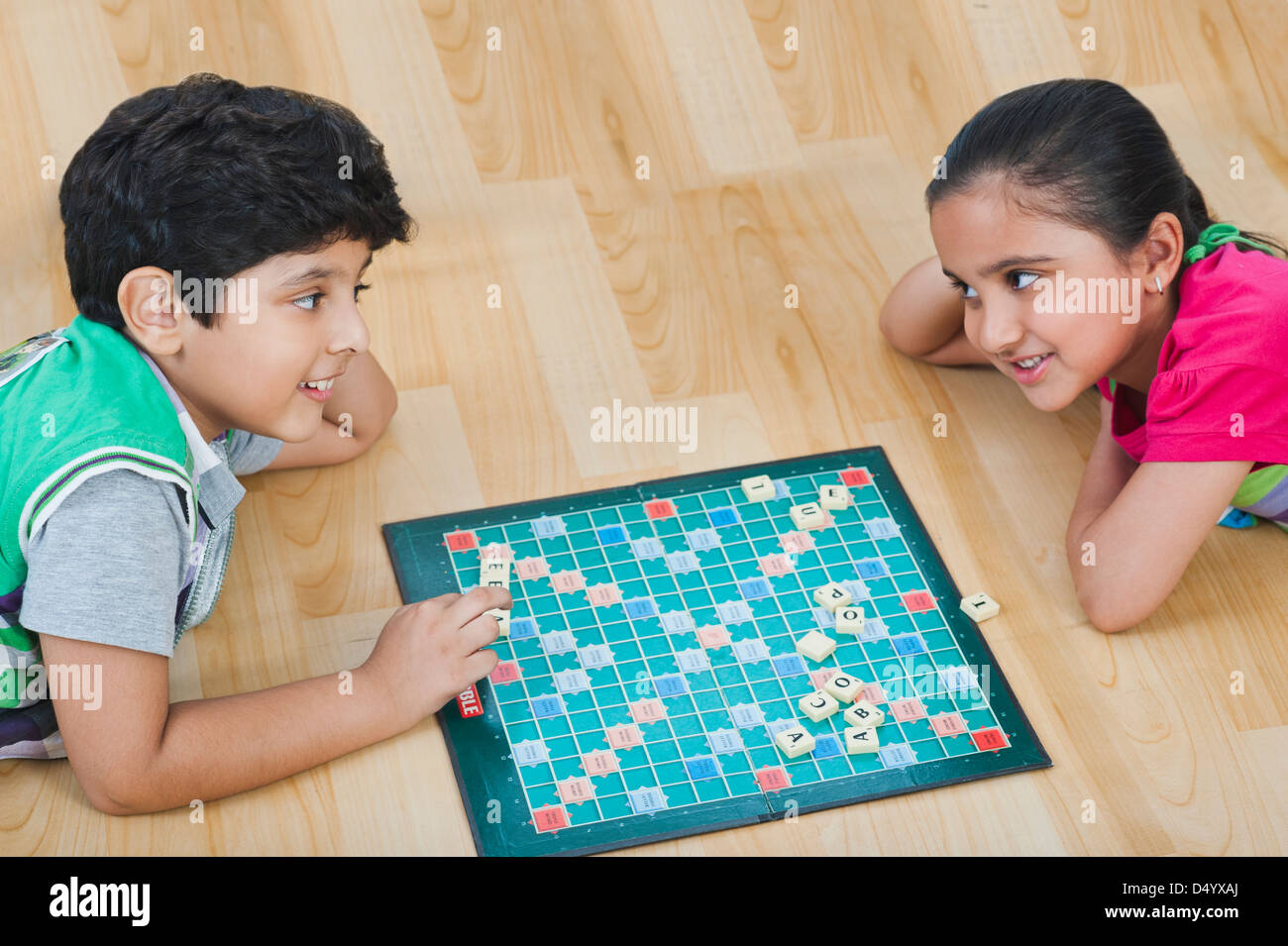 Children playing crossword puzzle game Stock Photo