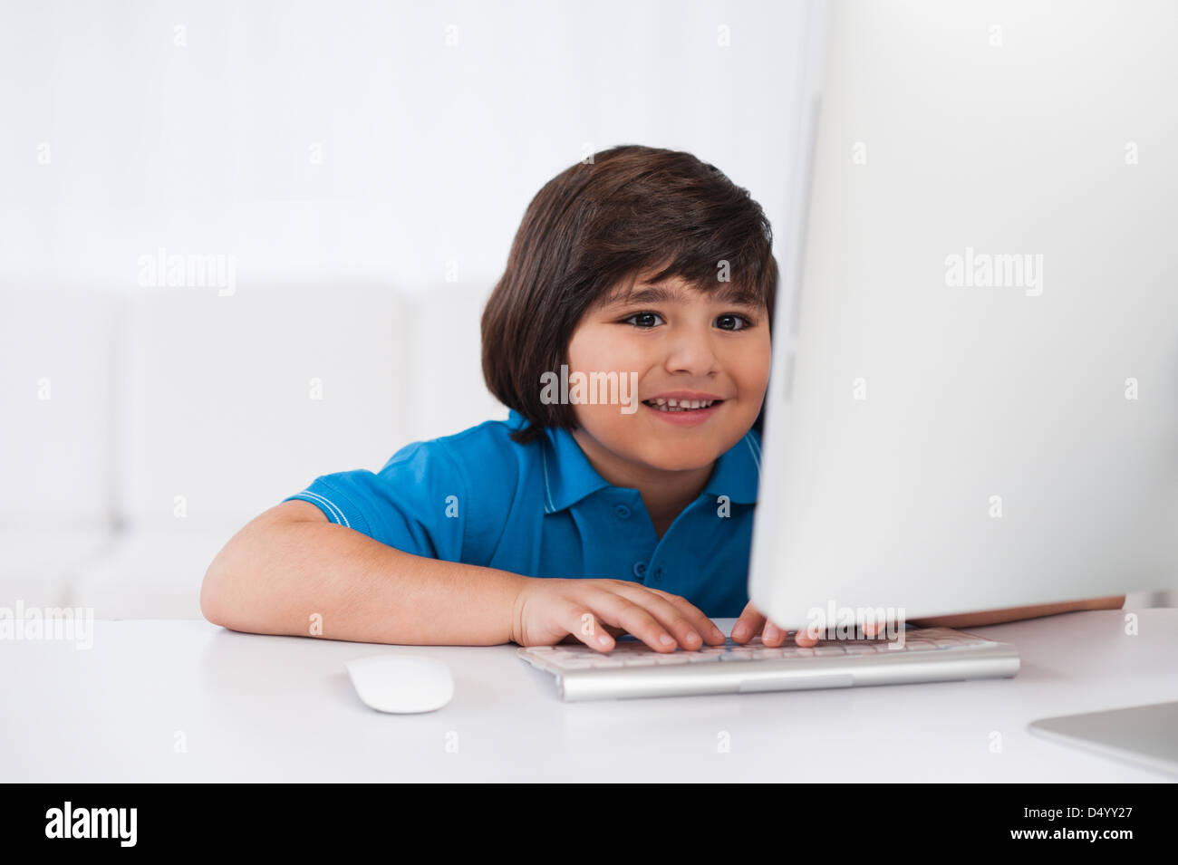 Boy using a desktop computer Stock Photo