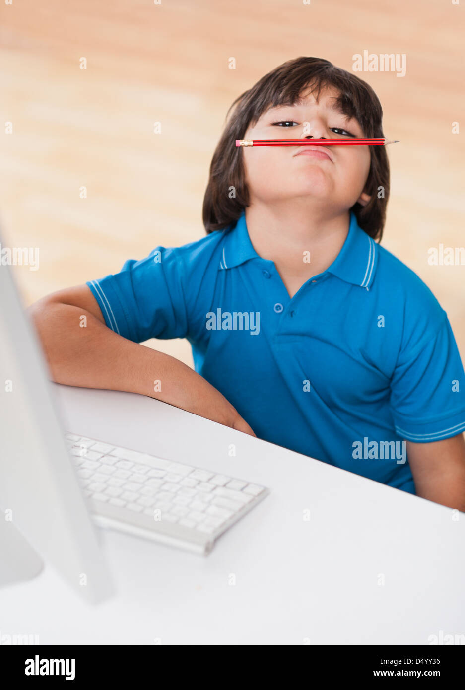 Boy balancing pencil on his face Stock Photo Alamy