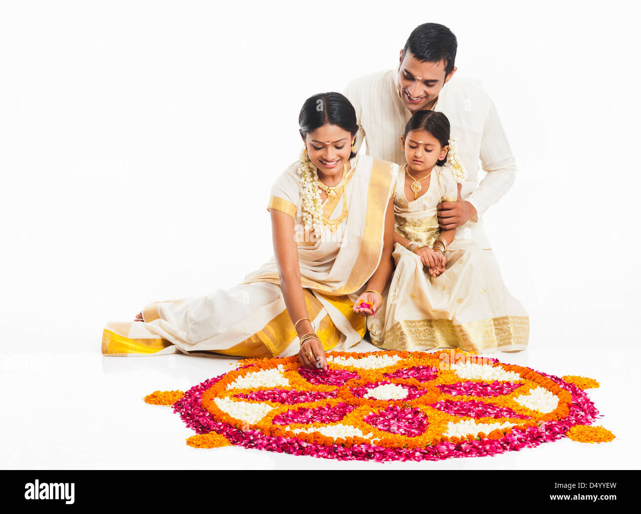South Indian family making a rangoli of flowers at Onam Stock Photo - Alamy