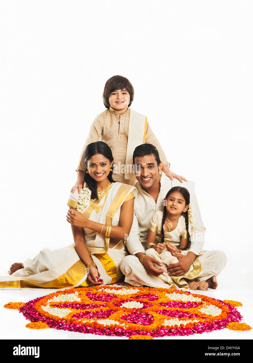 South Indian family making a rangoli of flowers at Onam Stock Photo - Alamy