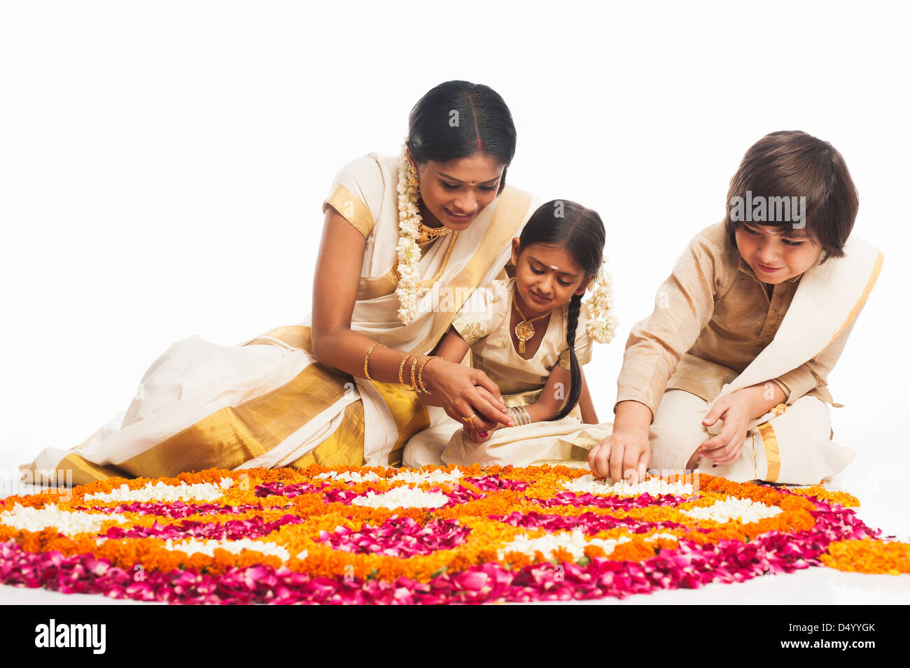South Indian family making a rangoli of flowers at Onam Stock Photo - Alamy