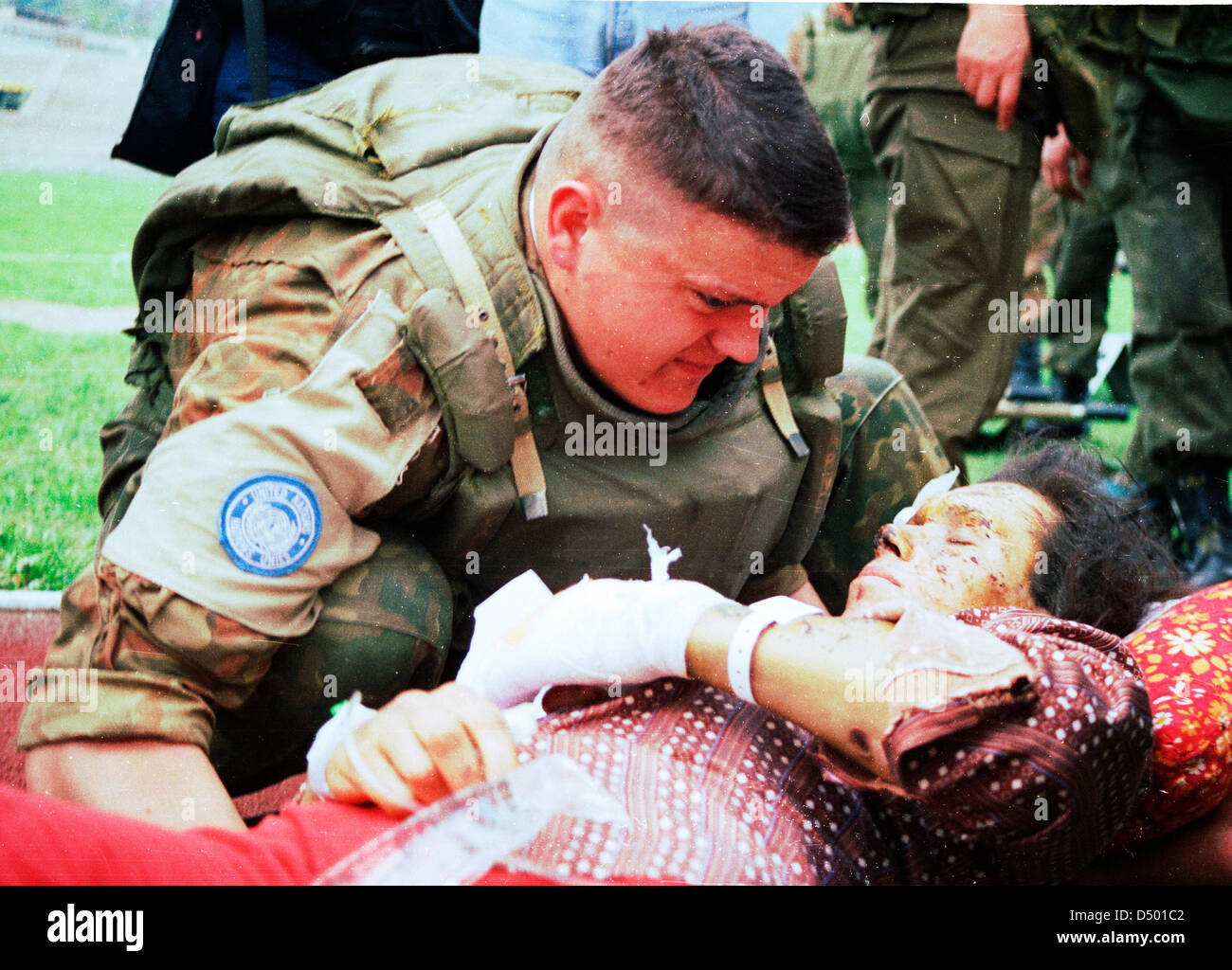 An Ukrainian soldier with the United Nations Protection Force (UNPROFOR) in Bosnia comforts a woman wounded during the siege of Gorazde at a medical evacuation center in Sarajevo, Bosnia, on Monday, April 4, 1994. Stock Photo