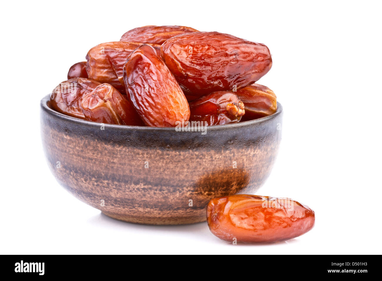 dried dates in brown cup isolated on white Stock Photo