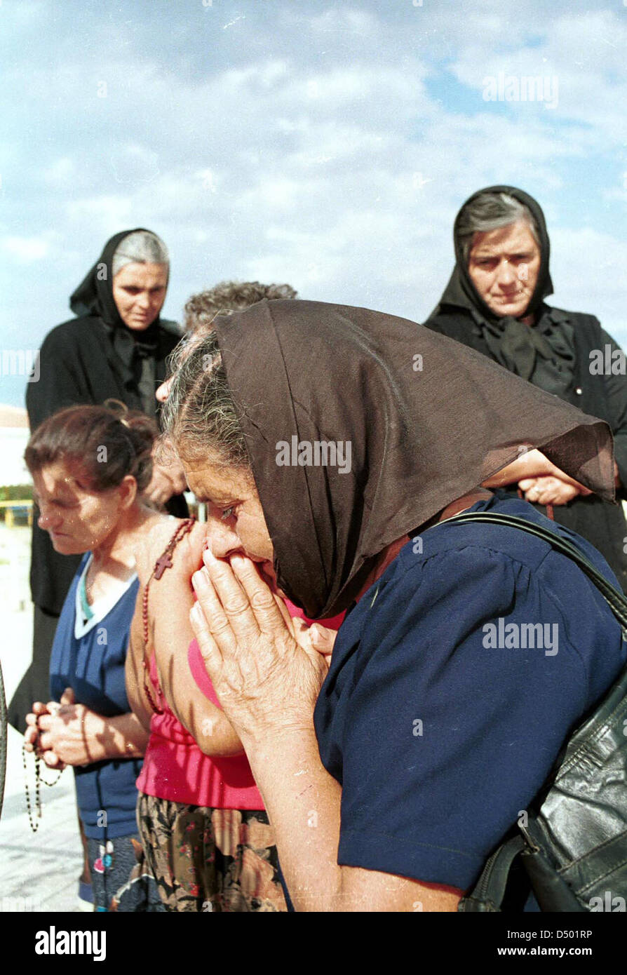 MEDJUGORIA, BOSNIA, 22 AUGUST 1993 --- Catholic pilgrims pray at a shrine to the Virgin Mary in the town of Medjugoria. Thousands of religious pilgrims annually make the trek to Medjugoria, where two teenage girls claim the Virgin Mary once appeared to them. Stock Photo