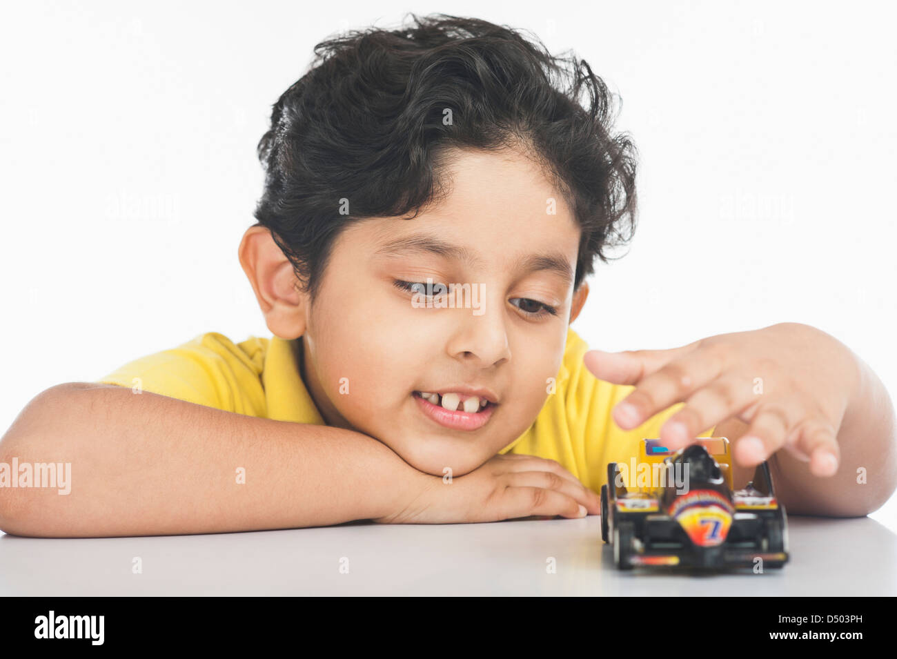 Boy playing with a toy car Stock Photo - Alamy