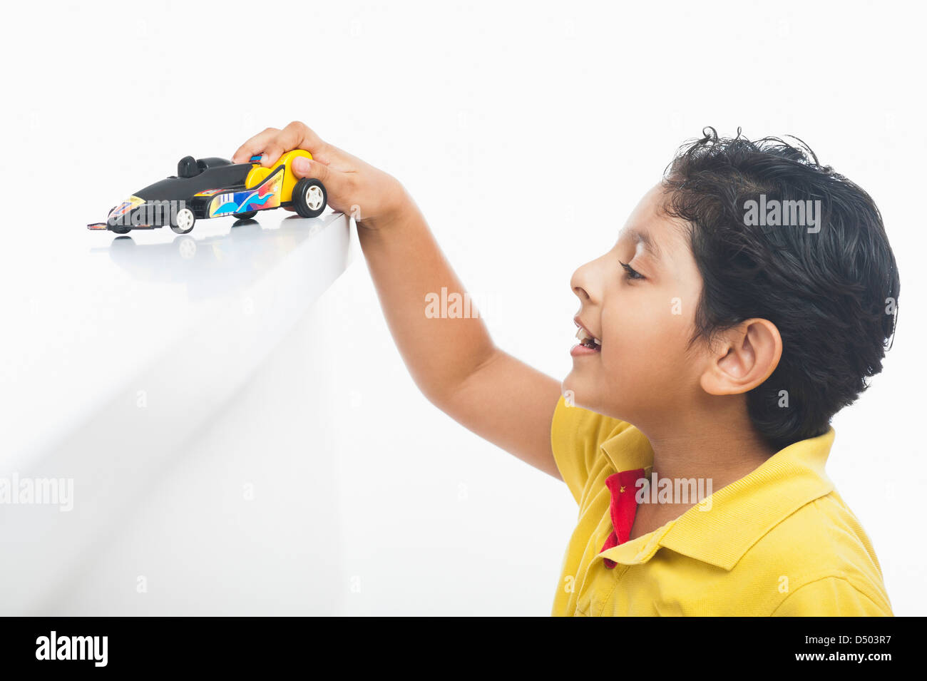 Boy playing with a toy car Stock Photo - Alamy