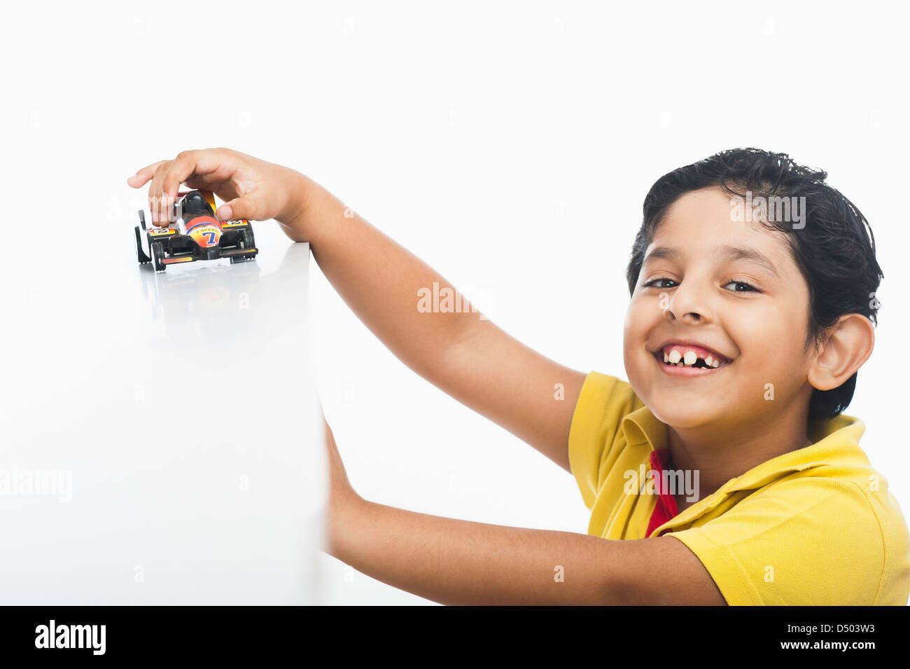Boy playing with a toy car Stock Photo - Alamy