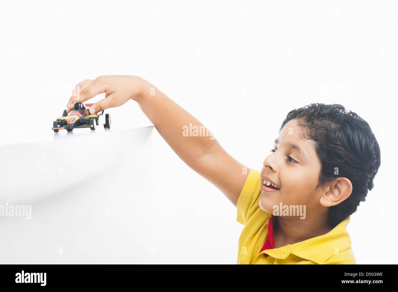 Boy playing with a toy car Stock Photo - Alamy
