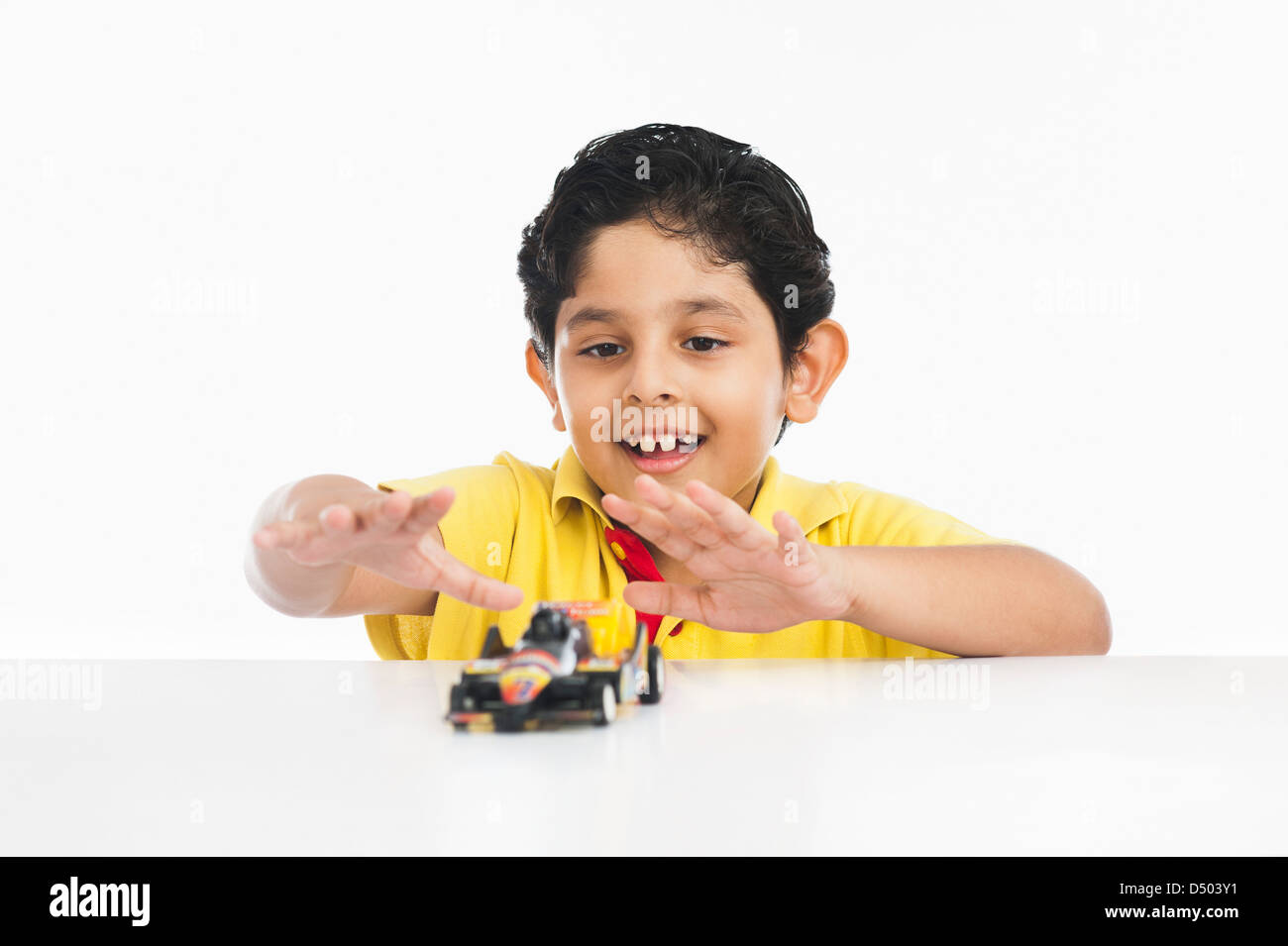 Boy playing with a toy car Stock Photo - Alamy